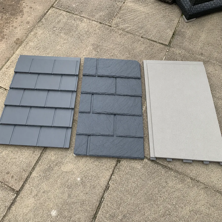 Tile, slate-effect and render finish samples for a conservatory roof laid out on a patio