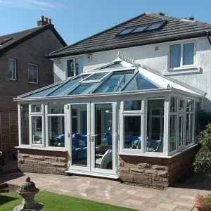 White uPVC conservatory with a replacement glass roof by Ultimate Home Solutions