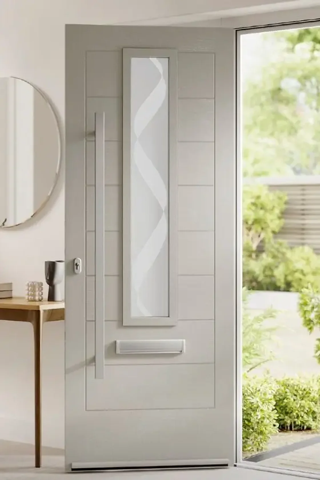 Pale grey composite front door with a slim etched glass panel, standing open onto a path