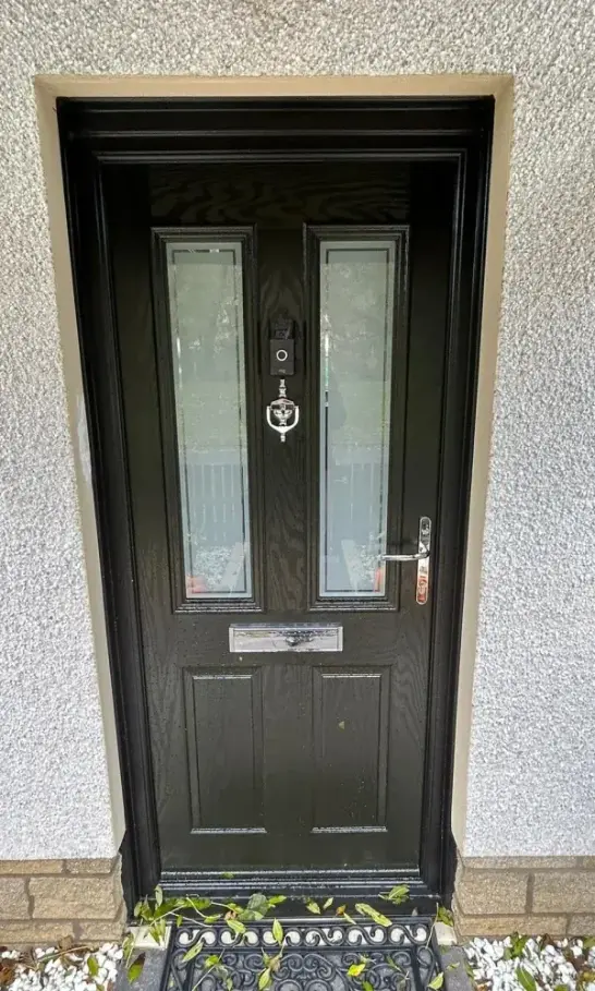 Black composite front door with two tall obscure glass panels and a chrome letterplate