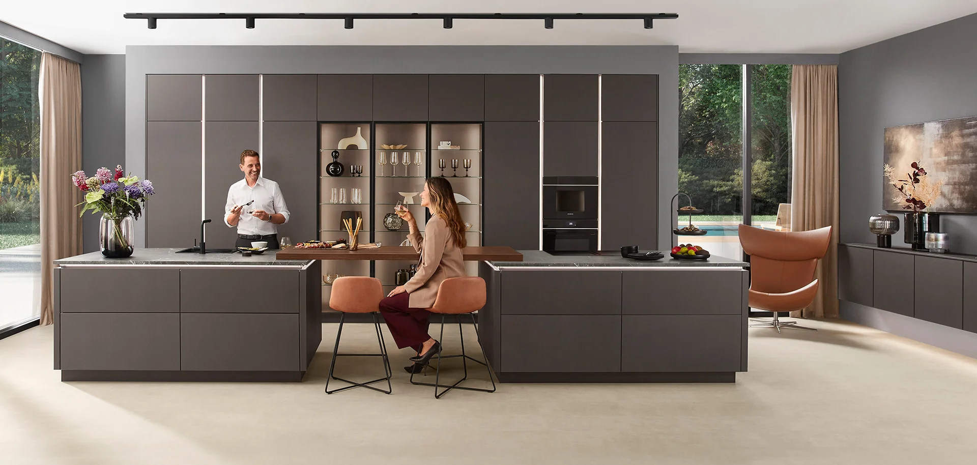 Sleek handleless kitchen in graphite with twin islands by Ultimate Home Solutions