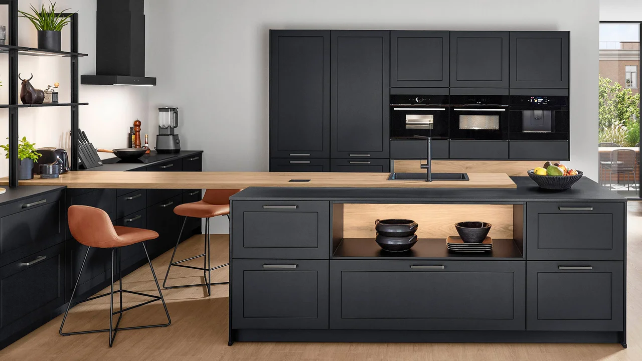 Navy shaker kitchen with island, solid wood worktop and bar stools by Ultimate Home Solutions
