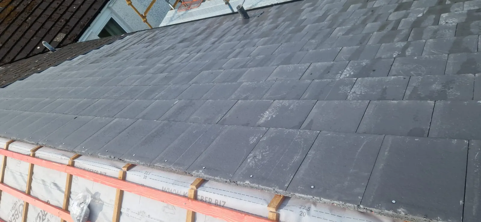 New slate-grey flat concrete tile roof, freshly laid, by Ultimate Home Solutions