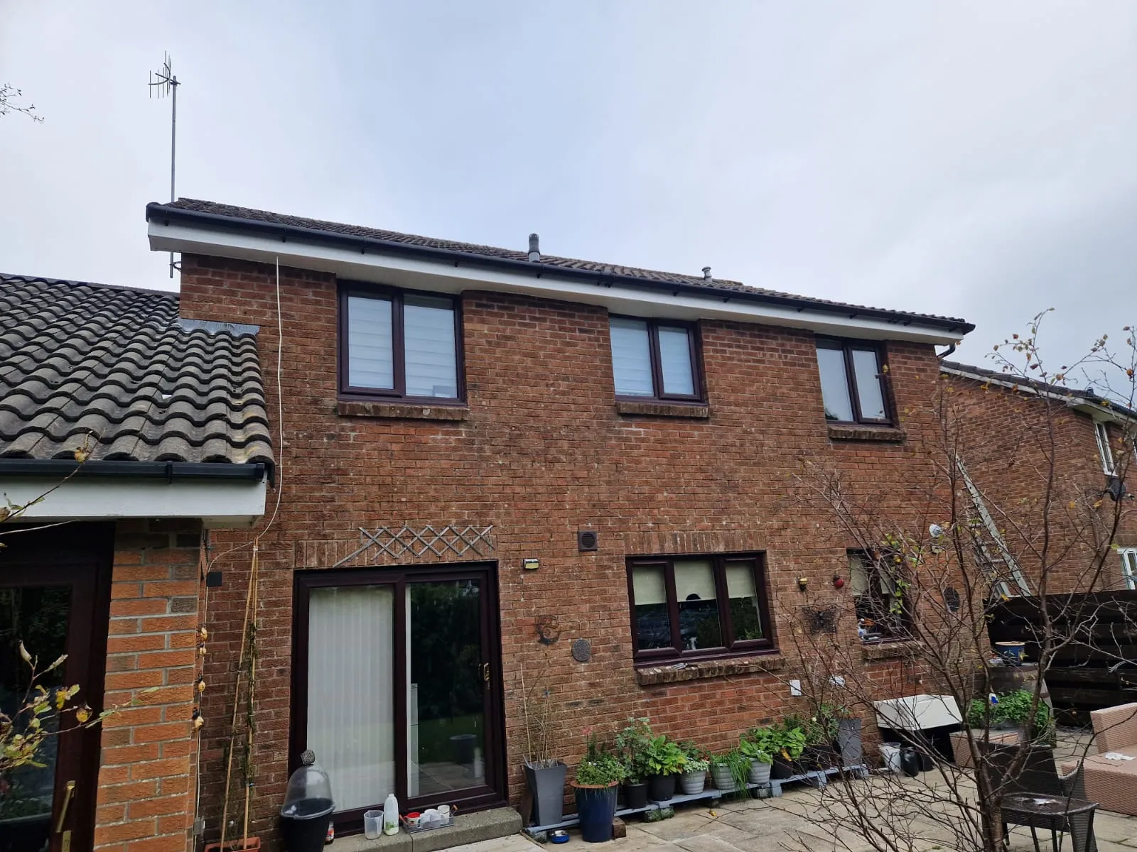 Rear elevation with new white fascia and black guttering on brick by Ultimate Home Solutions